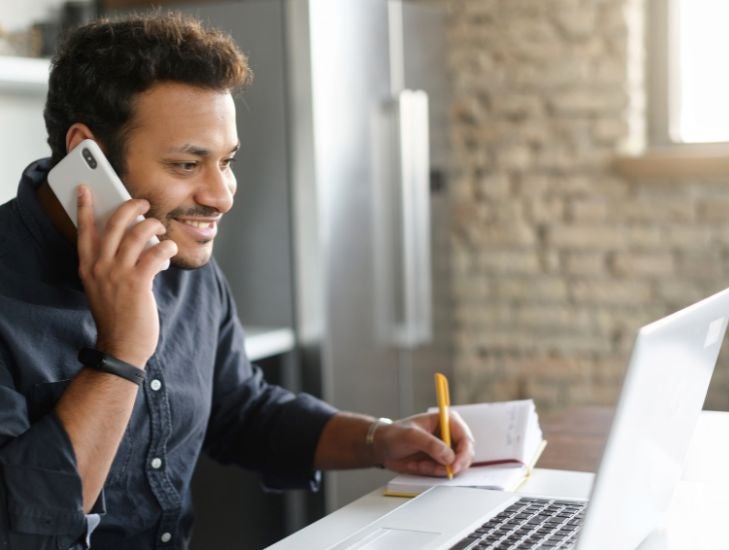 Broker on phone and laptop